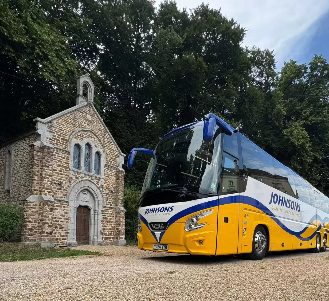 Coach parked by old building