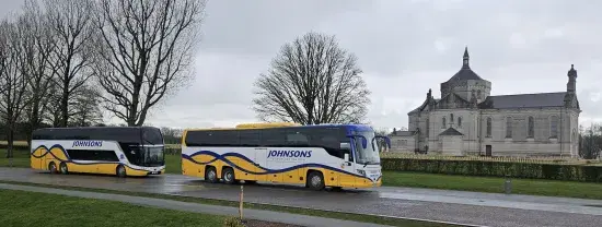 Coach in front of distant Church